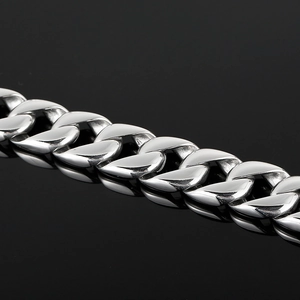 Macro shot of silver-colored stainless steel Cuban link chain with high-polished finish