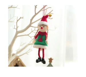 Detail of cute Christmas elf doll ornament with red hat and golden bell on white branch