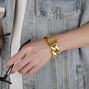 Close-up of gold Cuban link bracelet for men in wide vintage stainless steel style