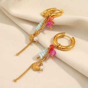Detail of 18K gold-plated tassel earrings featuring blue stones and white pearls
