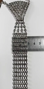 Macro shot showing the 3cm width measurement of a rhinestone fringe necktie necklace