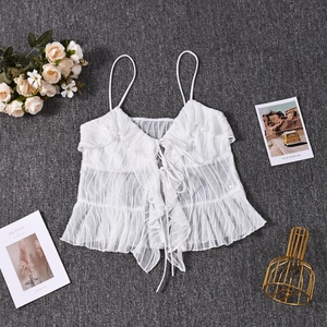 Detail of white mesh lace camisole featuring ribbon tie design and ruffled hem accents