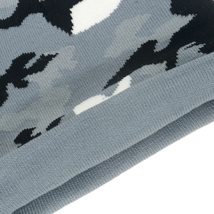 Winter knitted beanie cap with grey camouflage pattern and ribbed texture in close-up view