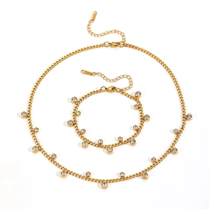 Golden titanium steel jewelry set with sparkling round zircon pendants on white background