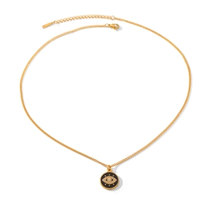 Detail of gold evil eye pendant with blue enamel and sparkling cubic zirconia crystal