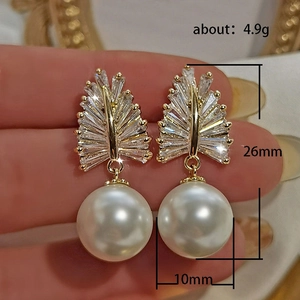 Baroque style pearl earrings with sparkling wheat-shaped cubic zirconia in gold