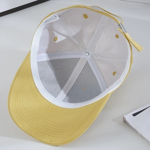 Detail view of cotton baseball cap interior showing stitching and 100% cotton label