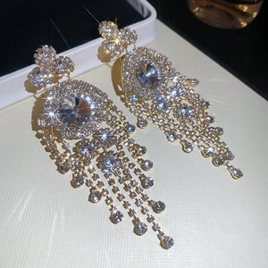 Macro shot of gold tassel earrings with sparkling rhinestones in a luxury vintage design