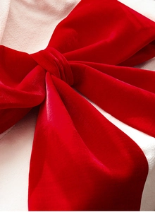 Close-up of premium red velvet texture on oversized Christmas bow decoration