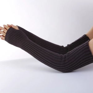 Detail of dark grey ribbed knit arm warmers with thumb holes and soft elastic fabric