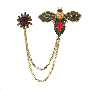 Vintage bee brooch with gold chains and red crystal detailing for stylish suit lapels