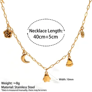 Gold stainless steel necklace with rose, moon and ghost charms on white background