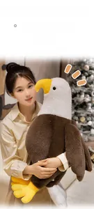 Asian model holding a soft bald eagle plush toy made of skin-friendly material