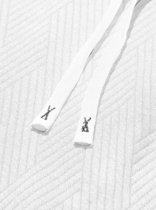 Close-up of white drawstring detail and twill fabric texture on a hooded sweatshirt