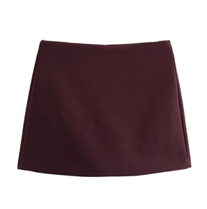 Detailed view of dark red mini skirt with straight cut and fine woven fabric texture
