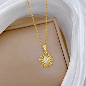 Golden sunflower necklace with sparkling zircons on a luxury jewelry display