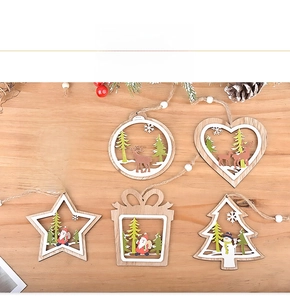 Detail of wooden laser-cut Christmas ornaments with reindeer and snowman scenes