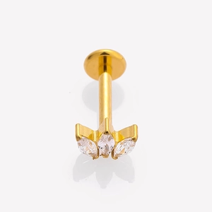 Macro detail of G23 titanium gold stud with three marquise zircon stones and flat back disc