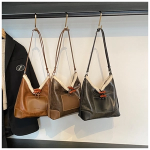 Detailed trio of vintage fuzzy bucket bags with horn toggles and sheepskin trim