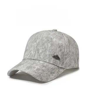 Detail of light grey textured baseball cap featuring a metal mountain peak side logo