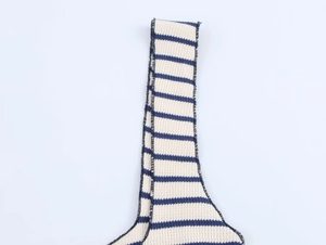 Detail of navy and cream striped ribbed knit fabric with clean overlock stitching