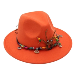 Close-up of bright orange fedora hat with ethnic beads and seashell decorative band