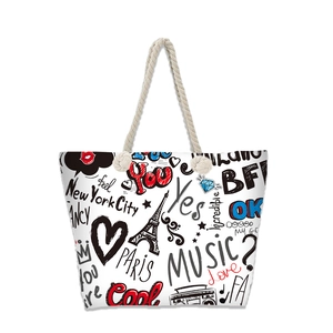 Close-up of canvas beach tote featuring graffiti prints and durable soft rope handles