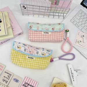 Quilted cotton pencil cases with cute cartoon prints and plush pom-poms for students