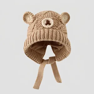 Detail showing knit texture and teddy bear ear design on a kids' winter hat