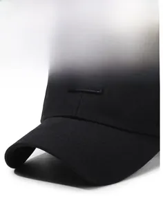 Detailed close-up of a black cotton baseball cap with white embroidery and reinforced brim