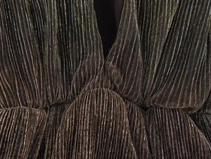 Detail of V-neckline and waist pleats on elegant metallic pinstripe sleeveless dress