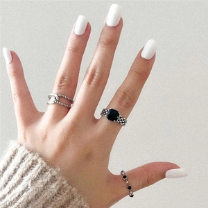 Close-up of vintage 925 sterling silver rings with black stones and twisted rope texture