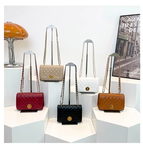 Quilted chain shoulder bags in red, beige, white, black and caramel displayed on steps