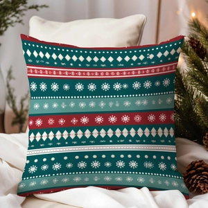 Detail of Christmas pillowcase with red and green snowflake patterns on white bedding