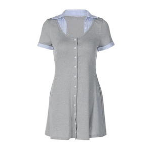 Close-up of the stylish contrast striped collar and button detail on the grey knit dress