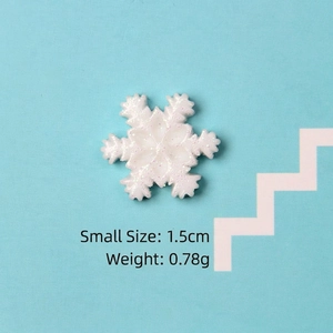 Macro detail of white glitter resin snowflake accessory sized 1.5cm for DIY crafts