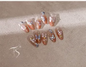 Macro detail of gradient pink butterfly nail stickers with glitter and rhinestones