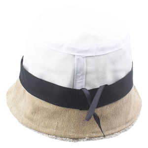 Detail of a patchwork bucket hat with a black ribbon bow and striped khaki brim