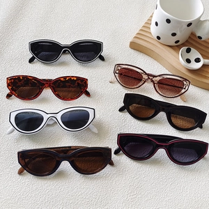 Collection of retro cat-eye Y2K sunglasses in various colors on a white texture