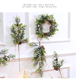 Detail of Christmas wreath and pine cone swags with white berries on white wall
