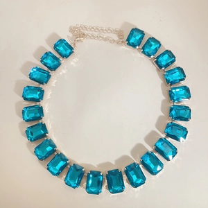 Rectangle bright blue crystal gemstone necklace with silver metal setting on white background