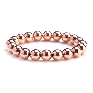 Macro shot of rose gold beaded bracelet with smooth polished mirror finish surface