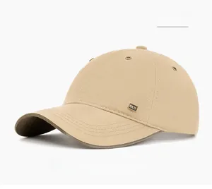 Close-up of khaki baseball cap featuring twill cotton fabric and metal logo detail