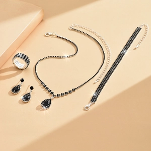 Elegant silver set with black rhinestones featuring a necklace, bracelet, earrings, and ring