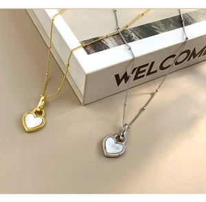Close-up of S925 sterling silver heart necklaces with white mother of pearl inlay