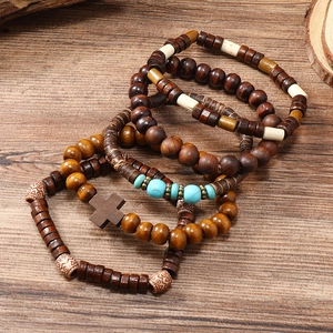 Bohemian multi-layer wooden bead bracelet set with cross pendant on wood surface