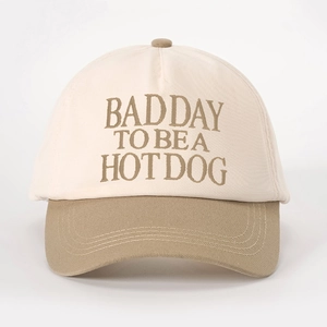 Close-up of embroidered 'BAD DAY TO BE A HOT DOG' text on contrast color baseball cap