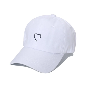 Minimalist white cotton baseball cap with heart embroidery in a clean Korean style