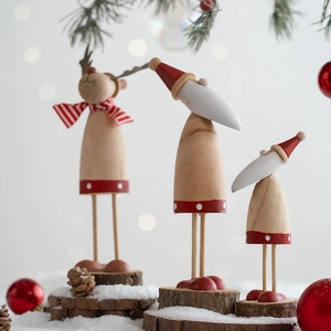 Three-piece wooden Christmas ornament set with Santa and reindeer on snowy log bases