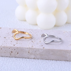 Minimalist wave-shaped stackable open rings in gold and silver finish on stone